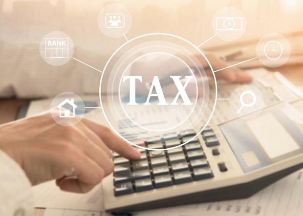 A Person Is Using a Calculator to Calculate Taxes — Sunshine Coast Financial Advisers in Maroochydore, QLD
