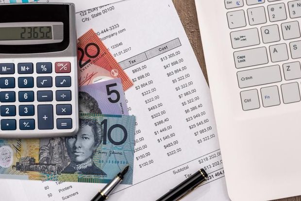 A Calculator, Money, a Pen, and A Laptop Are on A Table — Sunshine Coast Financial Advisers in Maroochydore, QLD