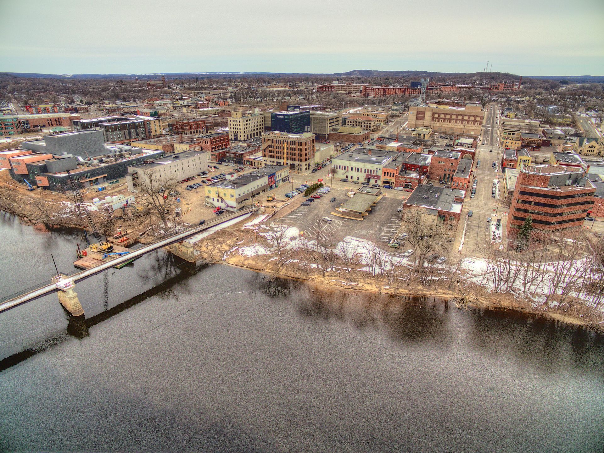 An aerial view of a city with a bridge over a river — Random Lake, WI — Hawley, Kaufman & Kautzer S.C.