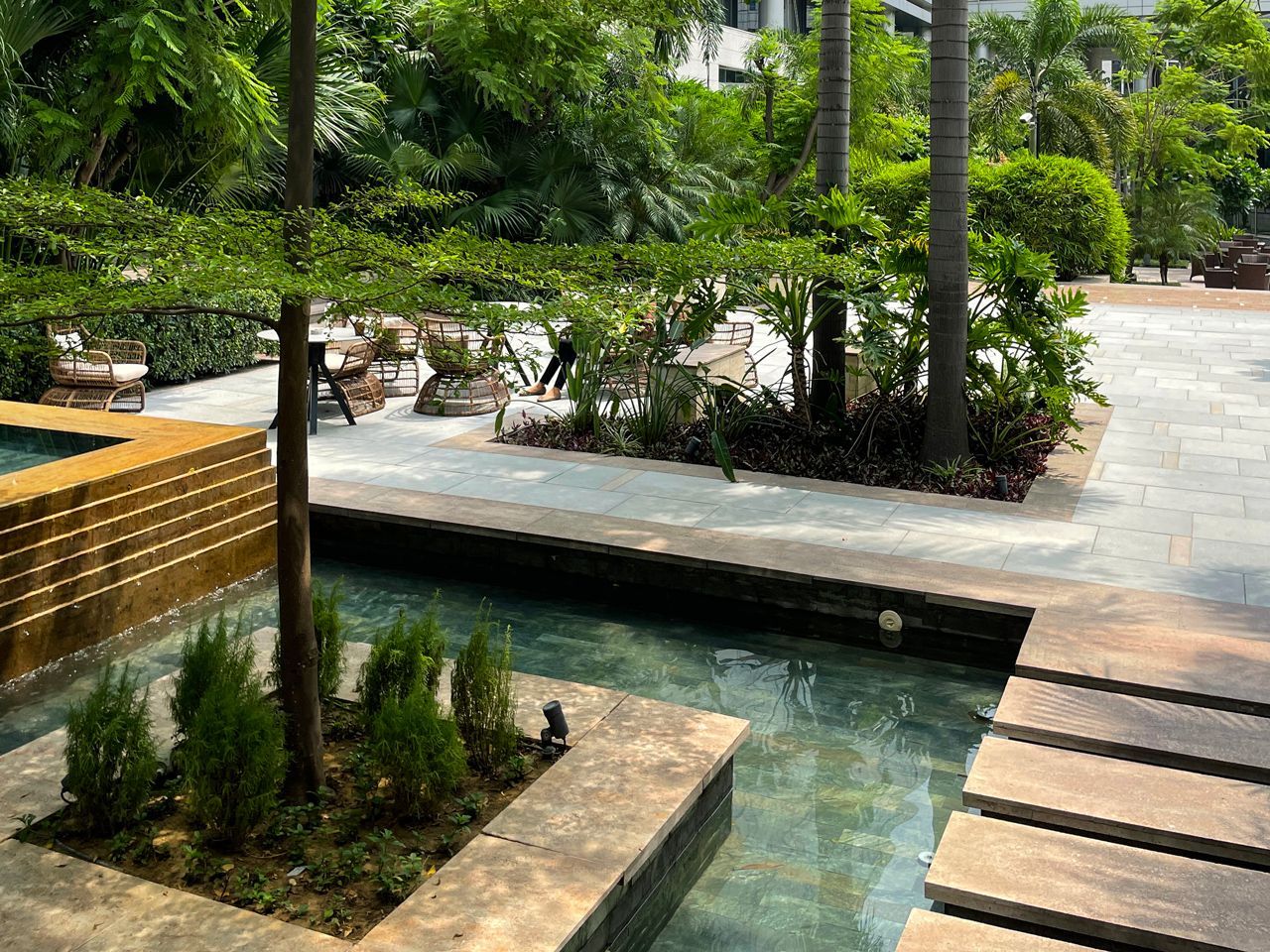 There is a swimming pool in the middle of the garden.