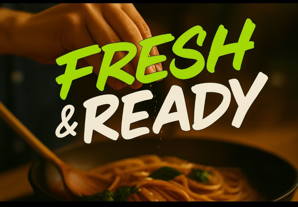 Hand sprinkling herbs over pasta in a pan, text