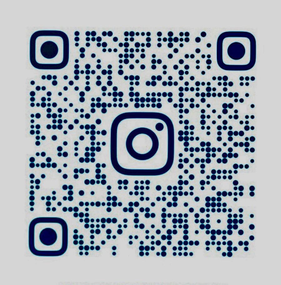 White brick house with dark roof, gutters, and landscaping; cloudy sky.