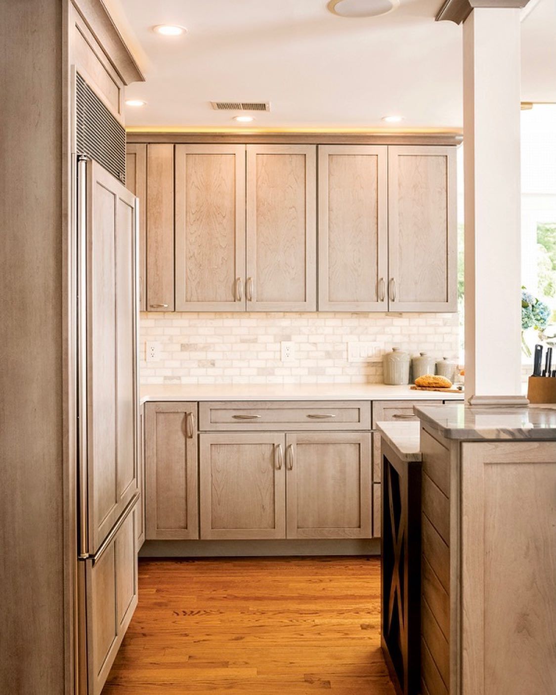 A white truck is towing a dump truck in a rocky area.