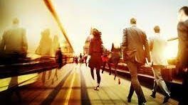 A group of people are walking across a bridge.