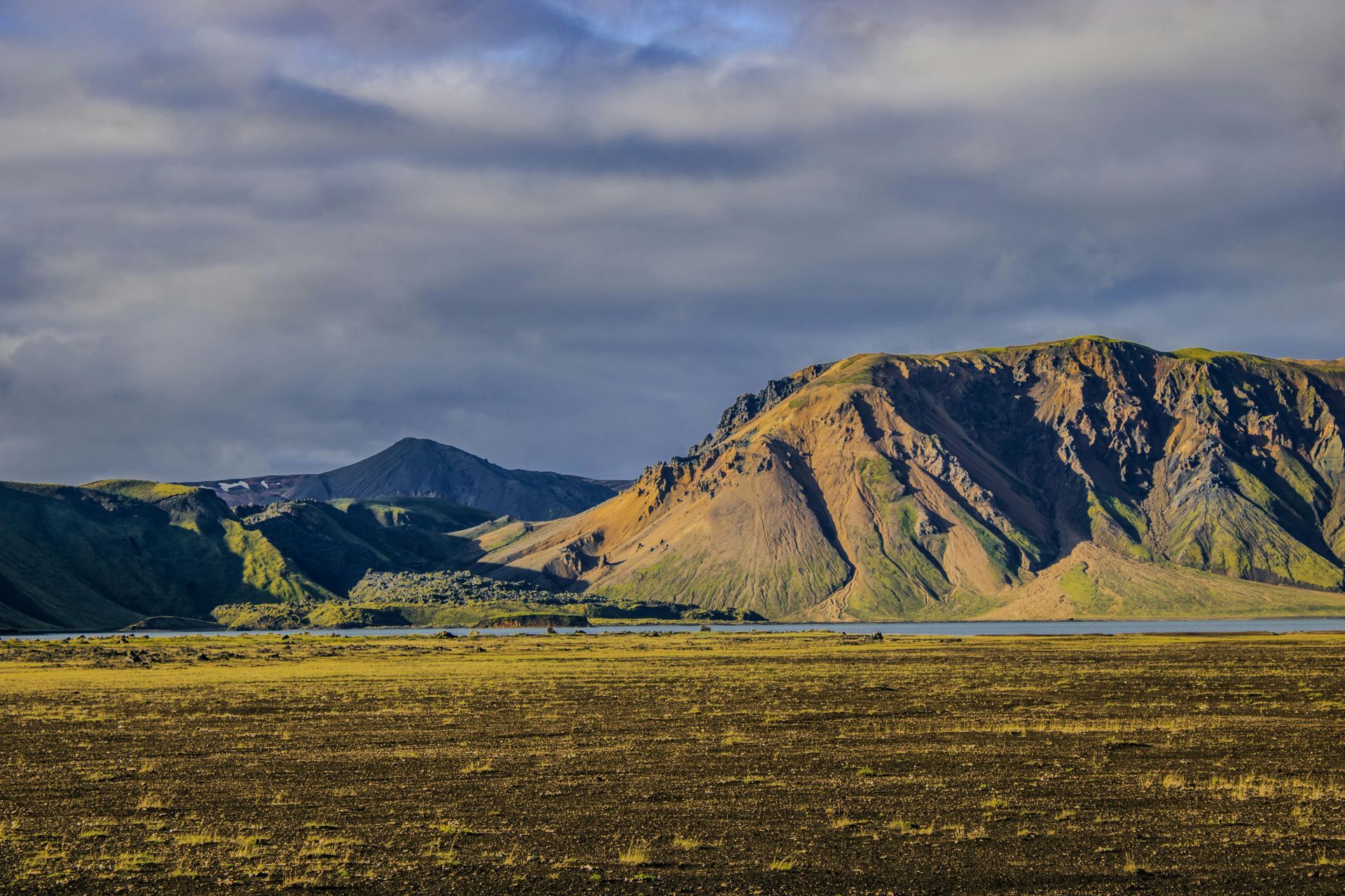 There is a mountain in the background and a lake in the foreground.