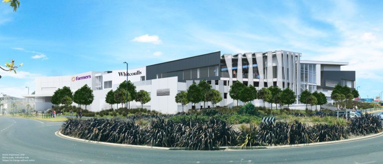 A modern building complex with white walls, dark trim, and decorative trees against a blue sky.