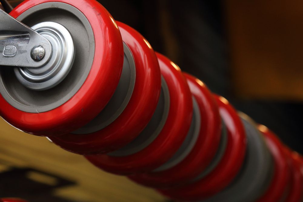 Red and Gray Casters in a Row of a Trolley — Gold Coast Laser And Pipe Bending in Mudgeeraba, QLD