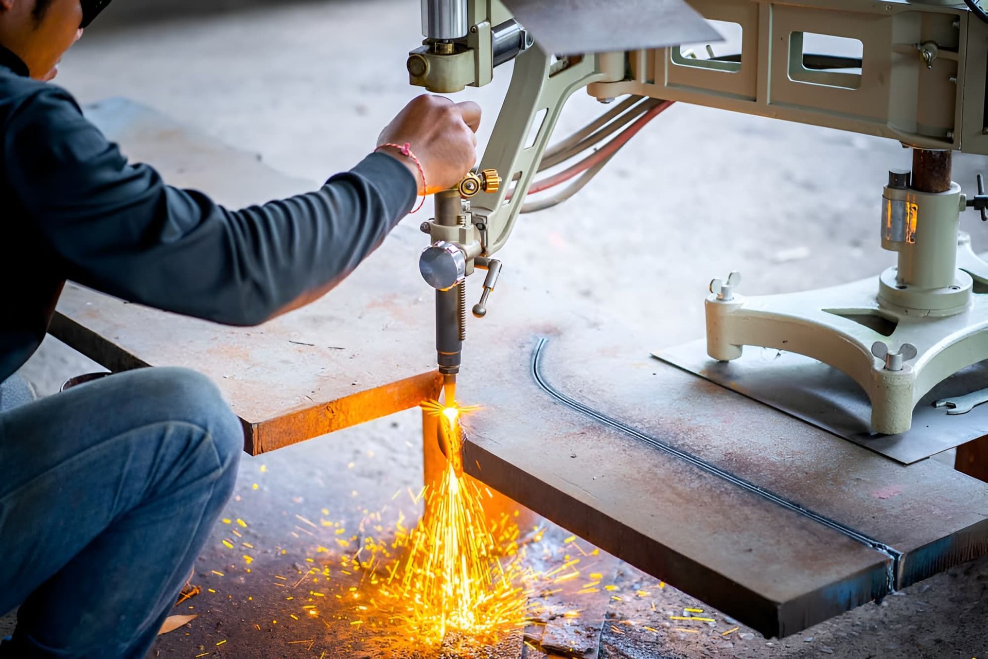 A Man Is Cutting A Piece Of Metal With A Machine - Gold Coast Laser And Pipe Bending in Mudgeeraba, QLD