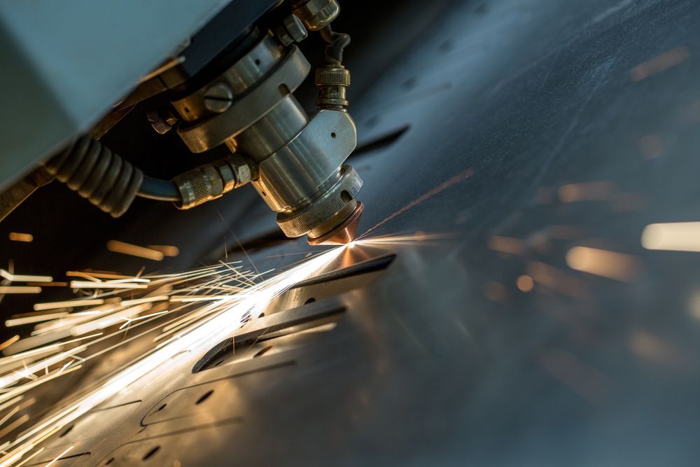A Machine Is Cutting A Piece Of Metal With Sparks Coming Out Of It - Gold Coast Laser And Pipe Bending in Mudgeeraba, QLD