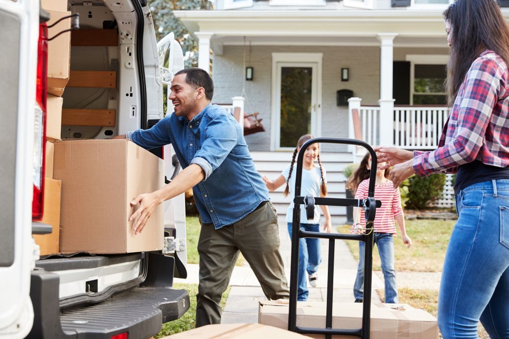 Family Unloading Boxes From a Van Using Trolley — Gold Coast Laser And Pipe Bending in Mudgeeraba, QLD