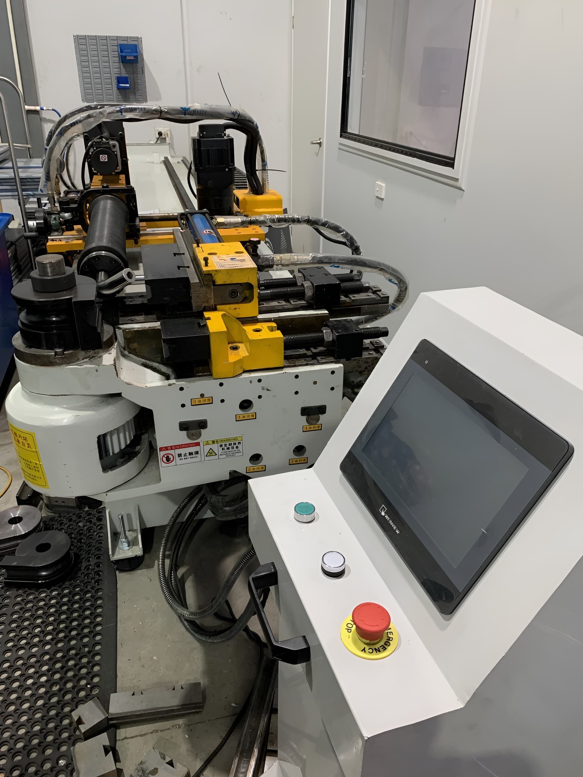 A Machine Is Sitting In A Room Next To A Control Panel - Gold Coast Laser And Pipe Bending in Mudgeeraba, QLD