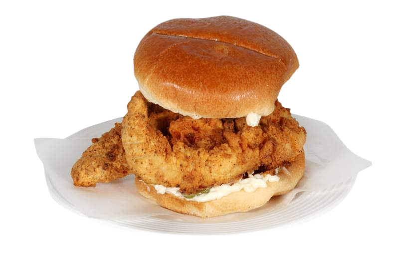A fried chicken sandwich on a bun on a white plate