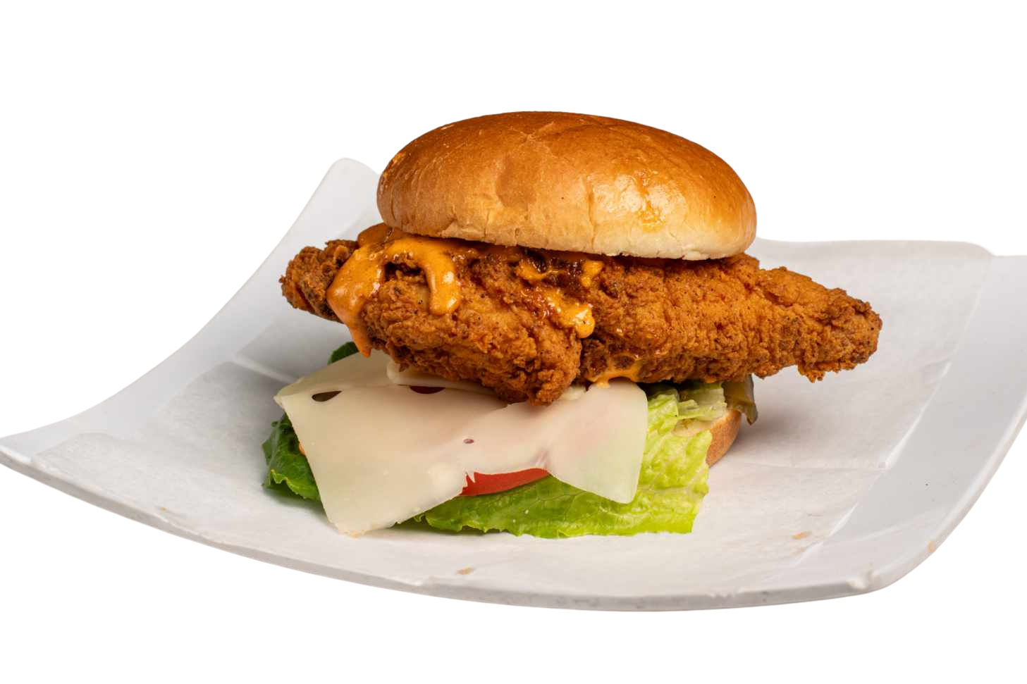 A chicken sandwich with lettuce , cheese and tomatoes on a white plate.