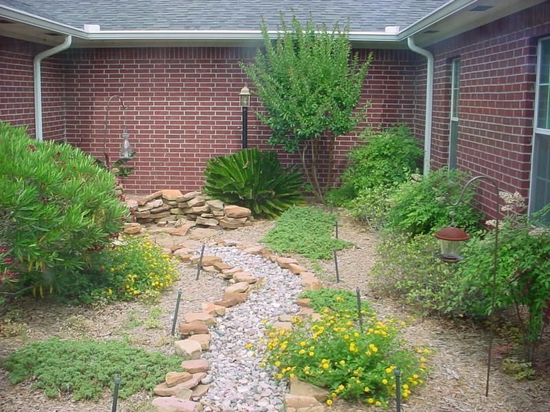 a brick house with a garden in front of it