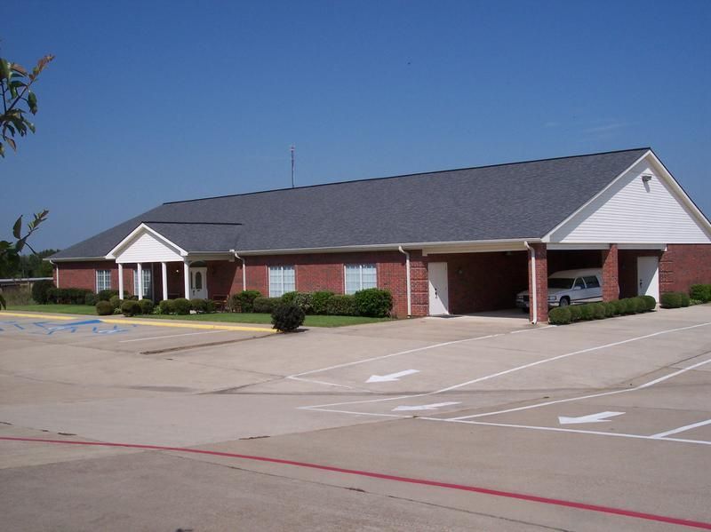 a brick building with a car parked in front of it
