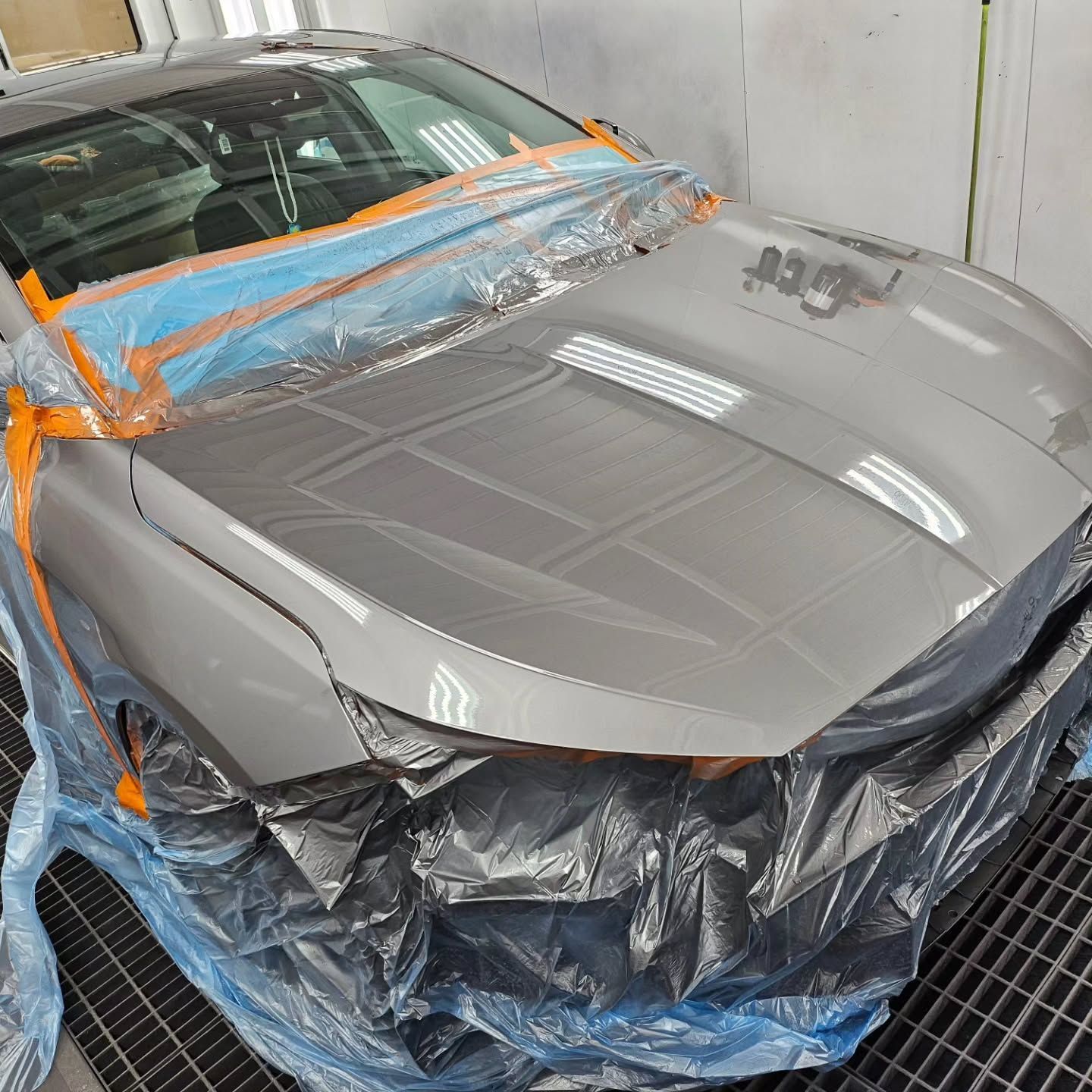 A car is wrapped in plastic and ready to be painted