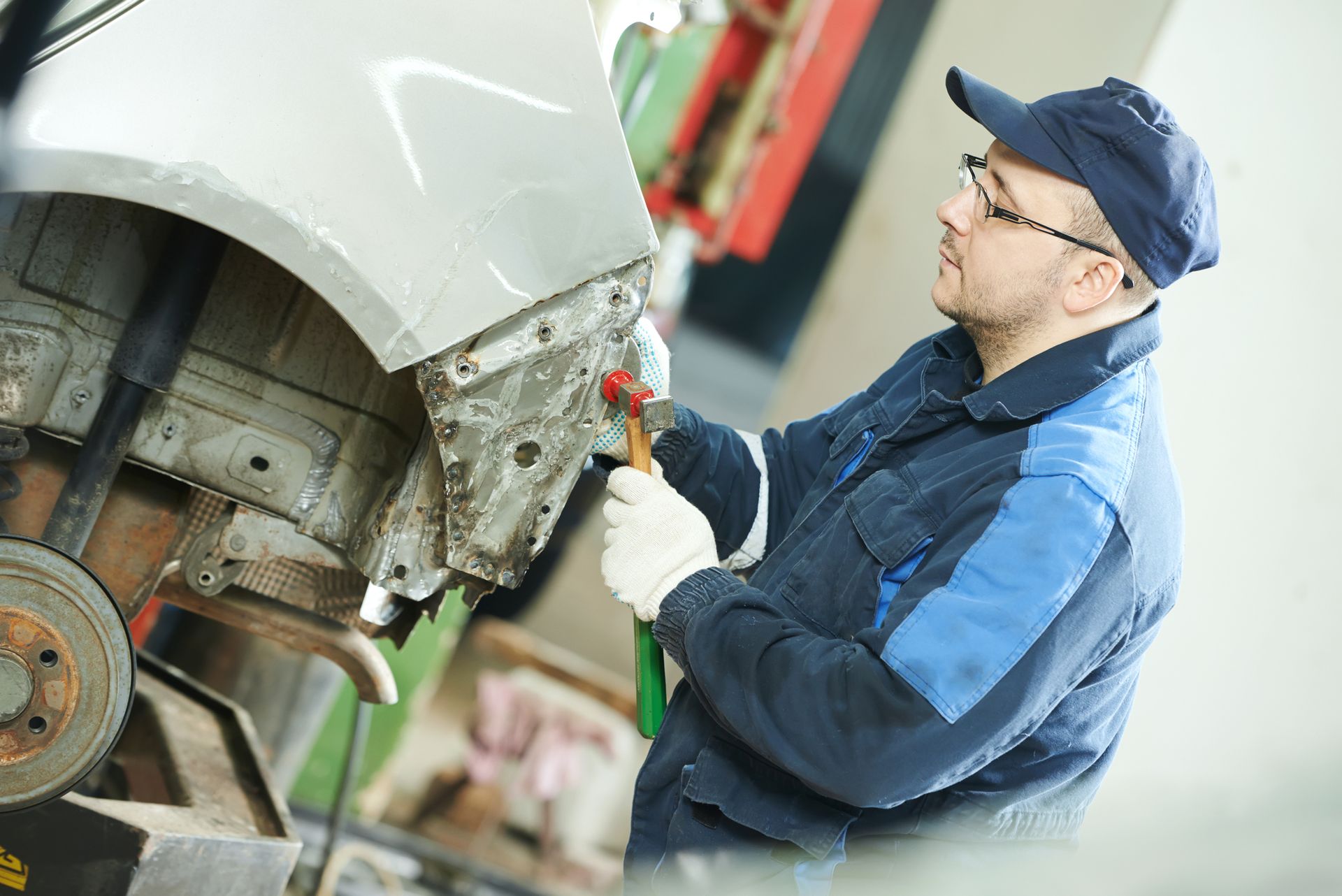 A man is working on a car in a garage.