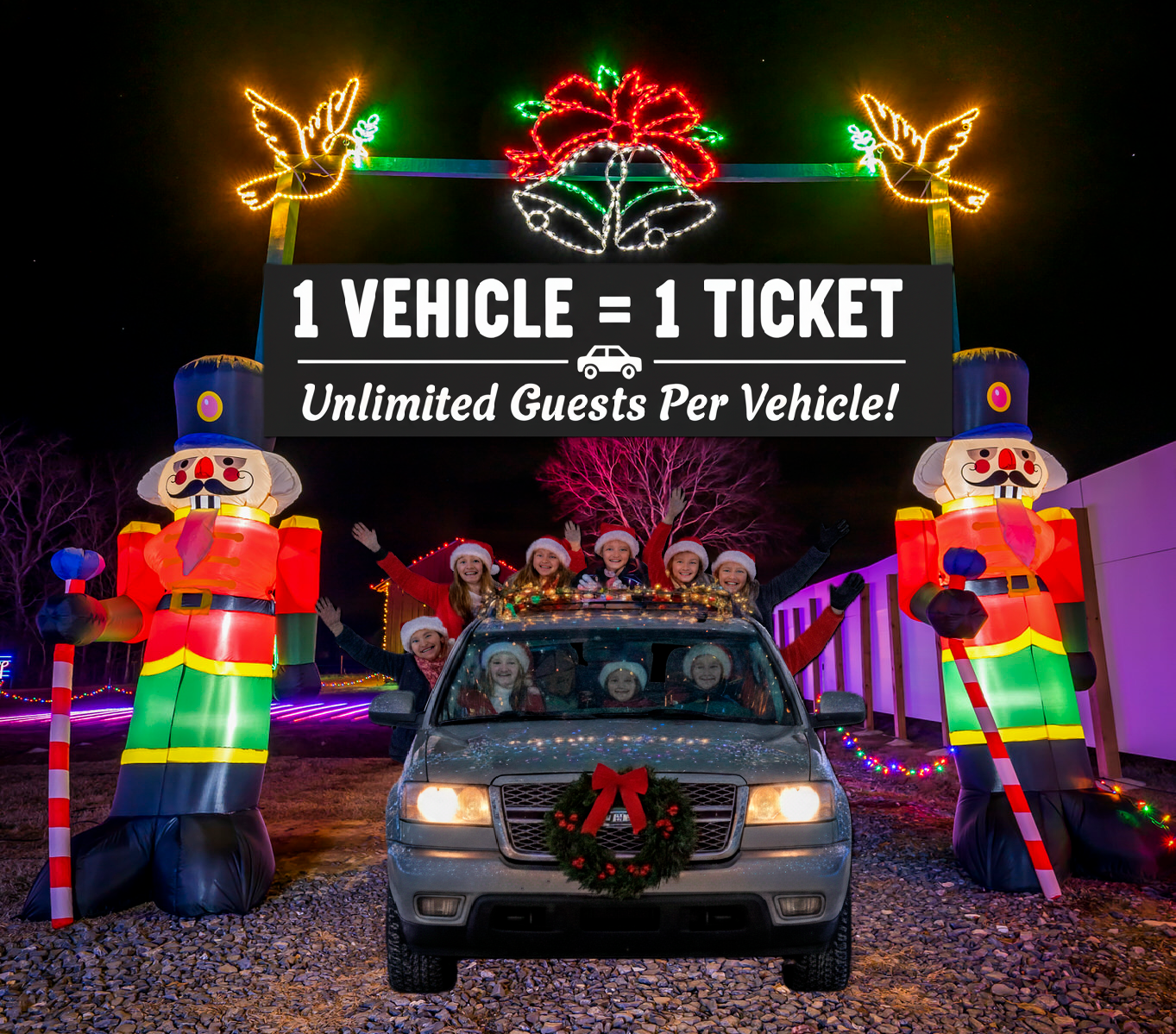 A car entering a Christmas light display; sign reads