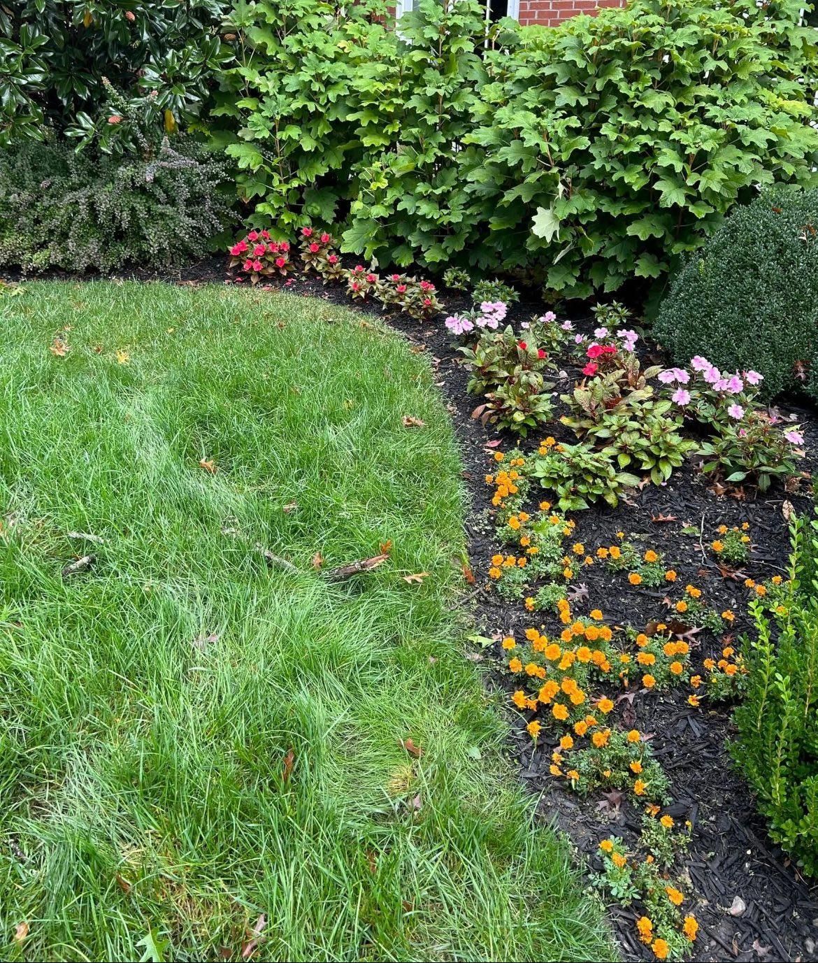 Living room with tall windows, leather chair, beige sofa, and fireplace.