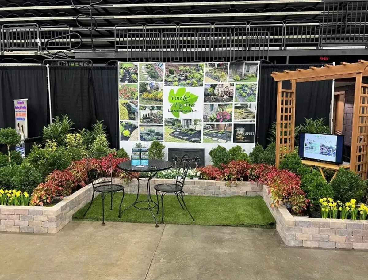 Two-story modern home with a wooden facade and balcony. Gray, white, and wood accents. Sunny outdoor setting.