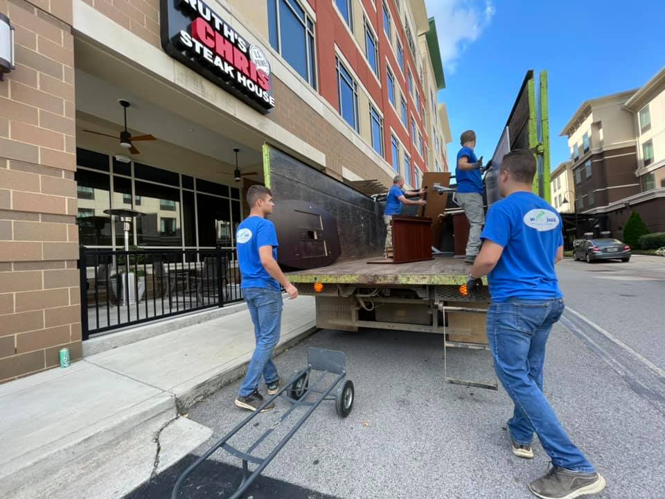 A group of men are loading furniture onto a truck.