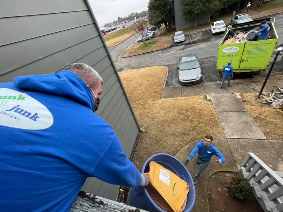 A man wearing a blue shirt that says junk on it