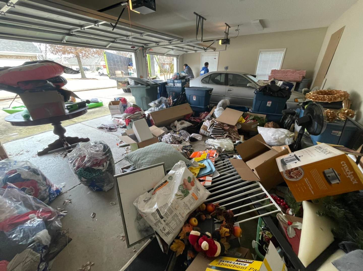 A garage filled with lots of junk and boxes.