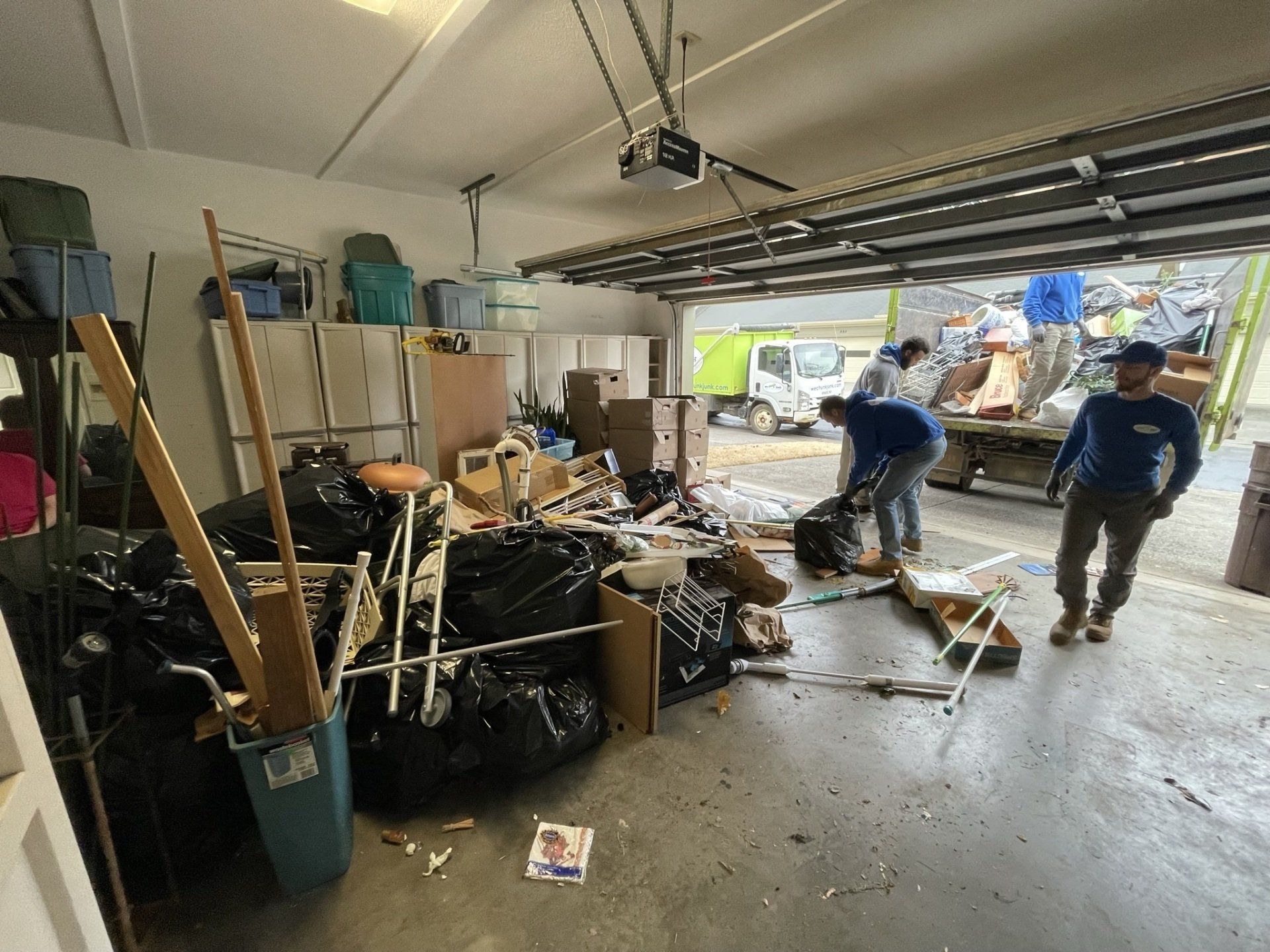 A garage filled with lots of trash and junk.