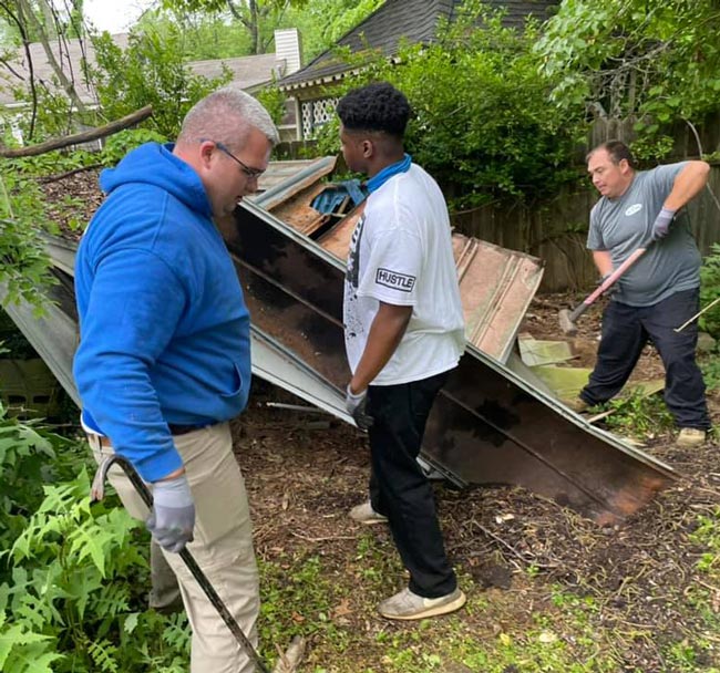 A man in a white shirt with the word purple on it
