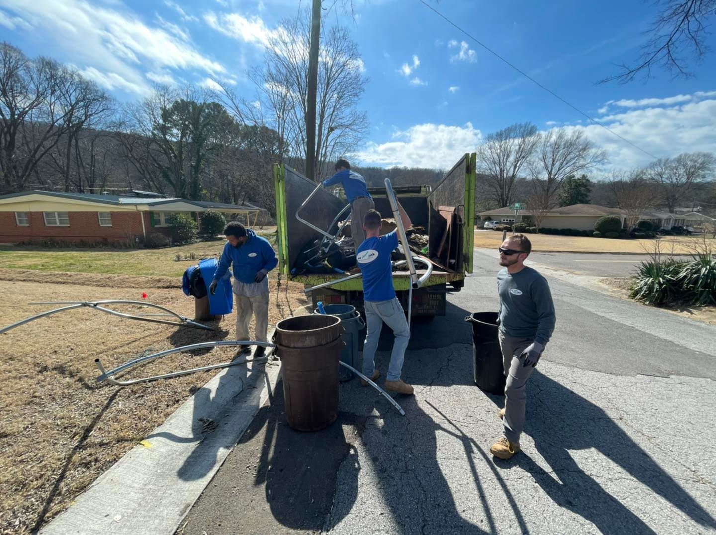 A group of people are standing in front of a truck.