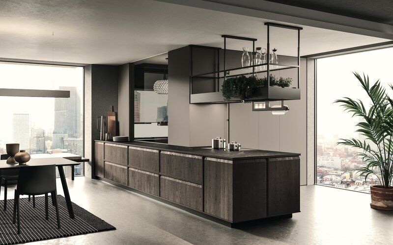 Modern kitchen with dark wood cabinetry and island, city view through large windows.