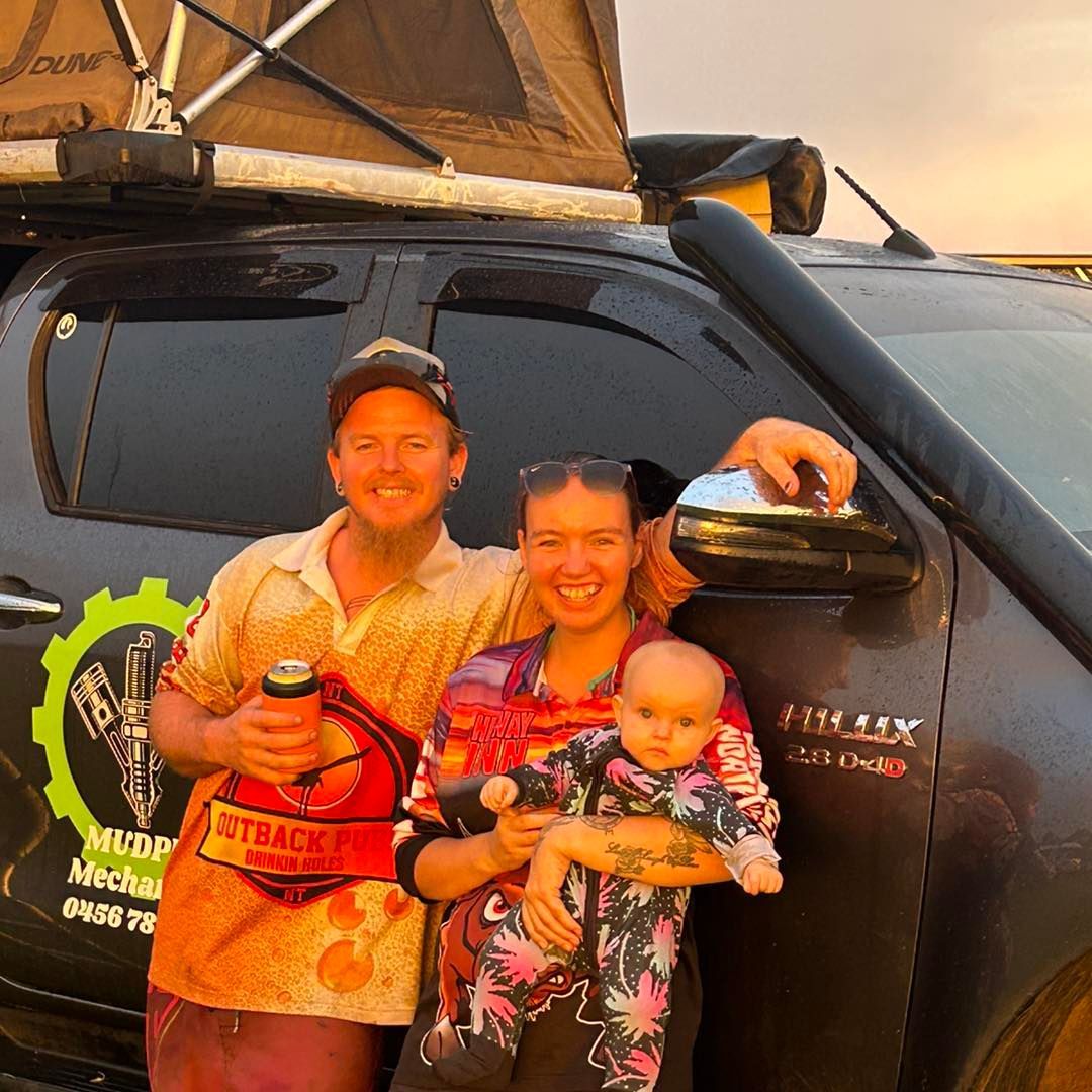 Family Posing in Front of a Black Truck With a Rooftop Tent — Mudpig Mechanical In Humpty Doo, NT