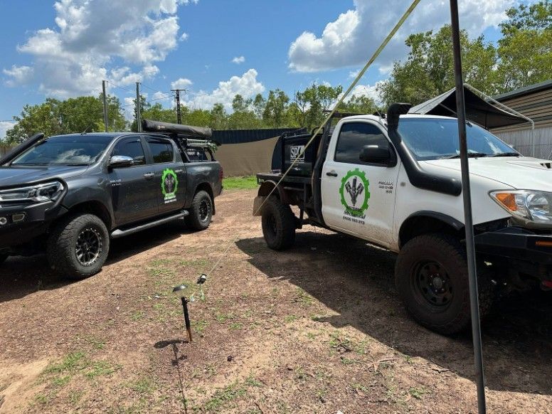 Two Off-road Trucks With Company Logos Parked Outside — Mudpig Mechanical In Humpty Doo, NT
