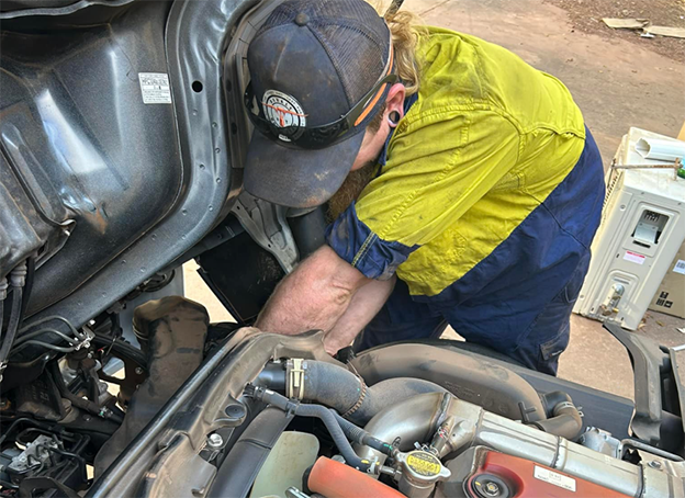 Mechanic Connecting Red and Blue Hoses — Mudpig Mechanical In Humpty Doo, NT