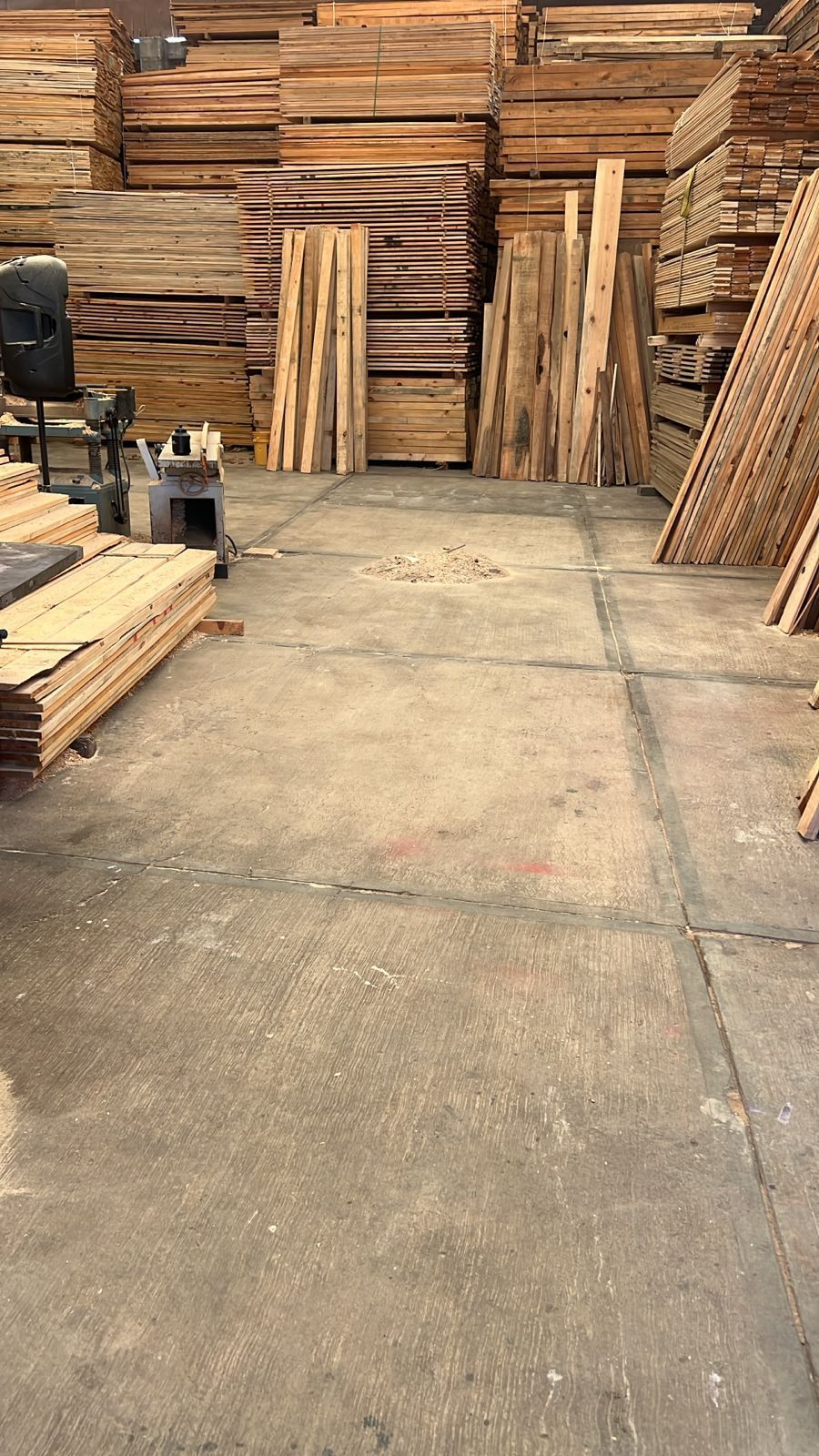 Un almacén lleno de tablas de madera y paletas.