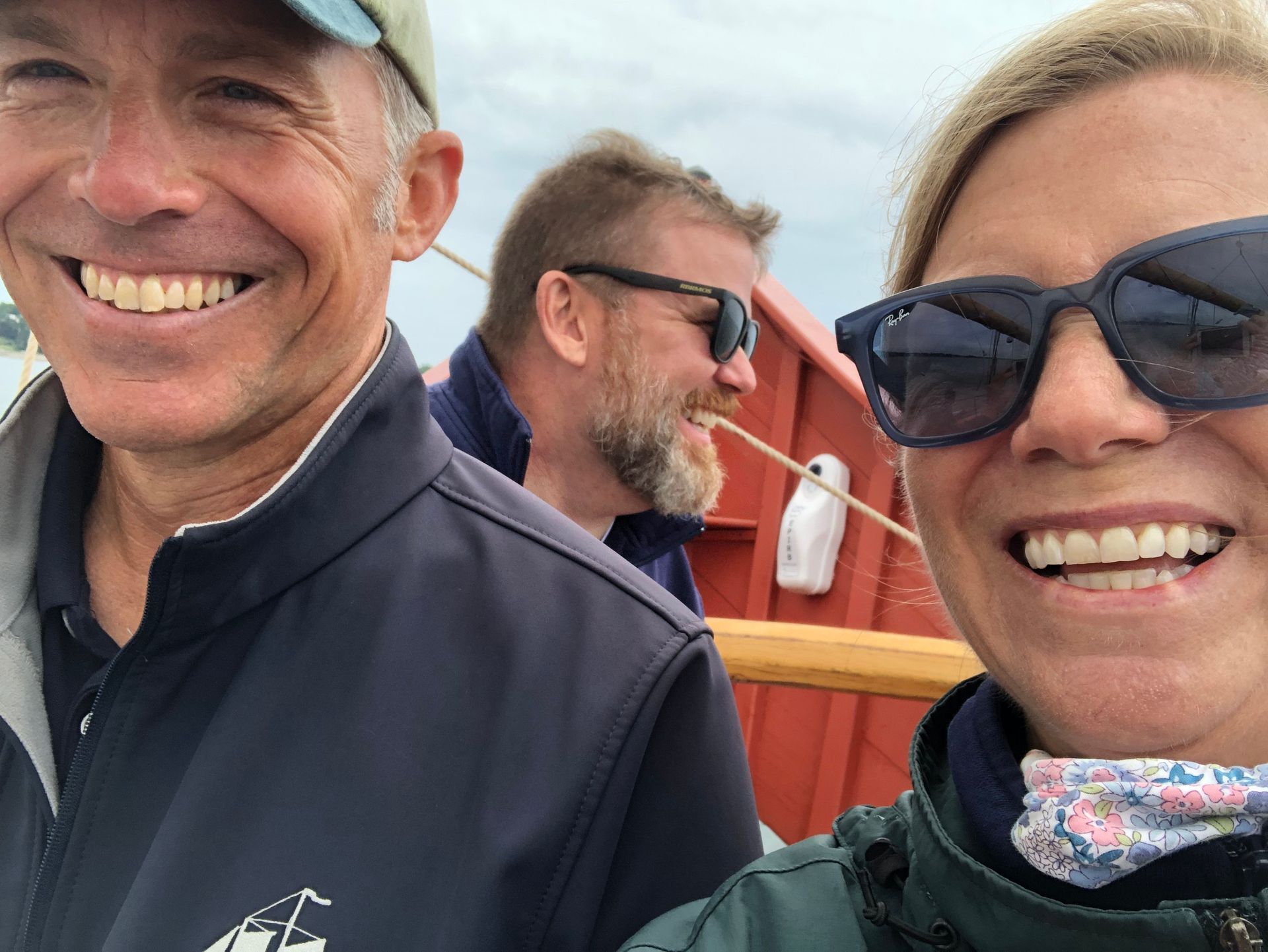 A man and a woman wearing sunglasses are smiling for the camera.