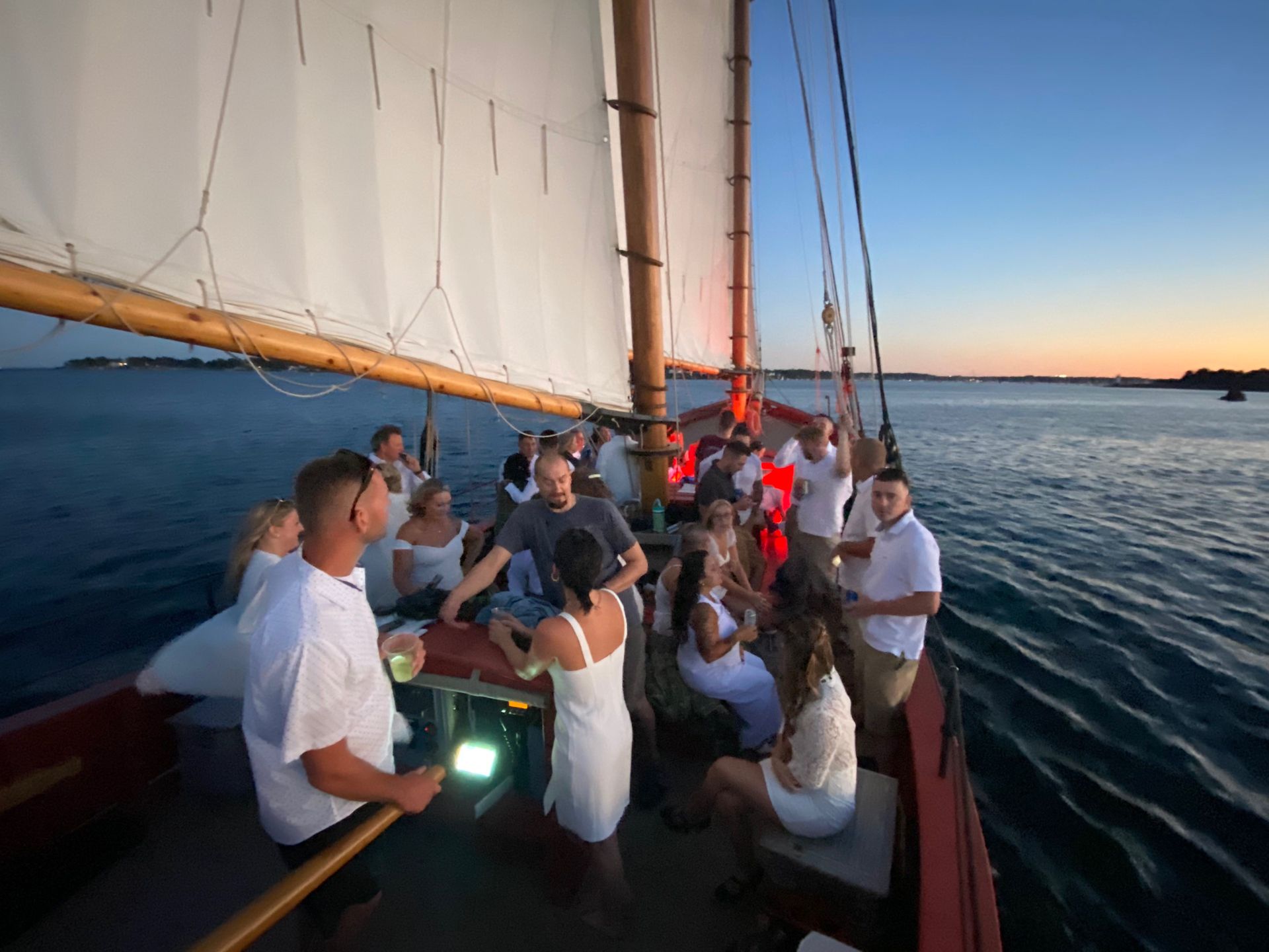 A group of people are sitting on a boat in the ocean.