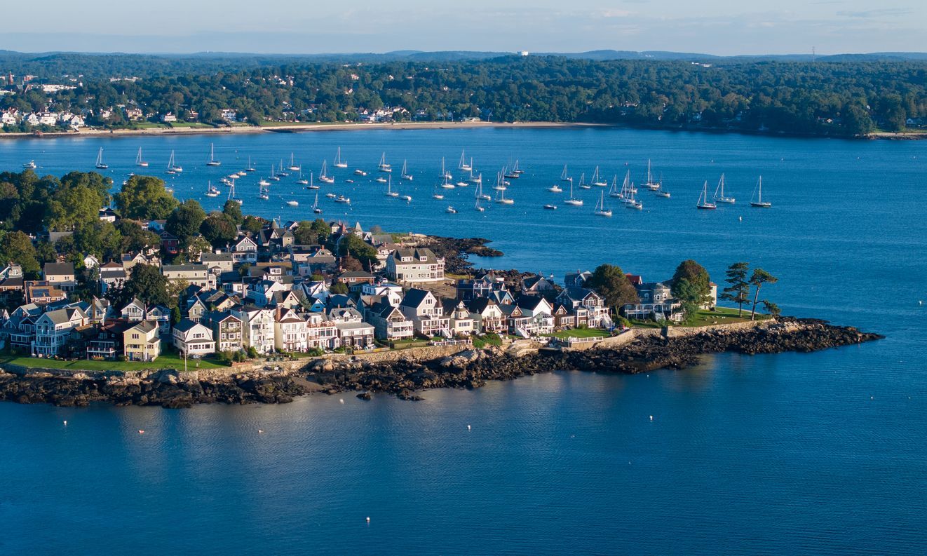 An aerial view of a small town on a small island in the middle of a large body of water.