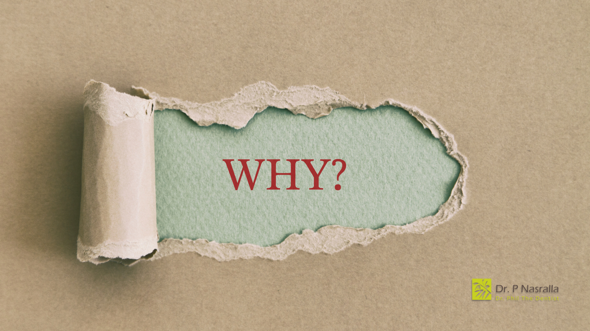 A piece of torn paper with the word why written on it.