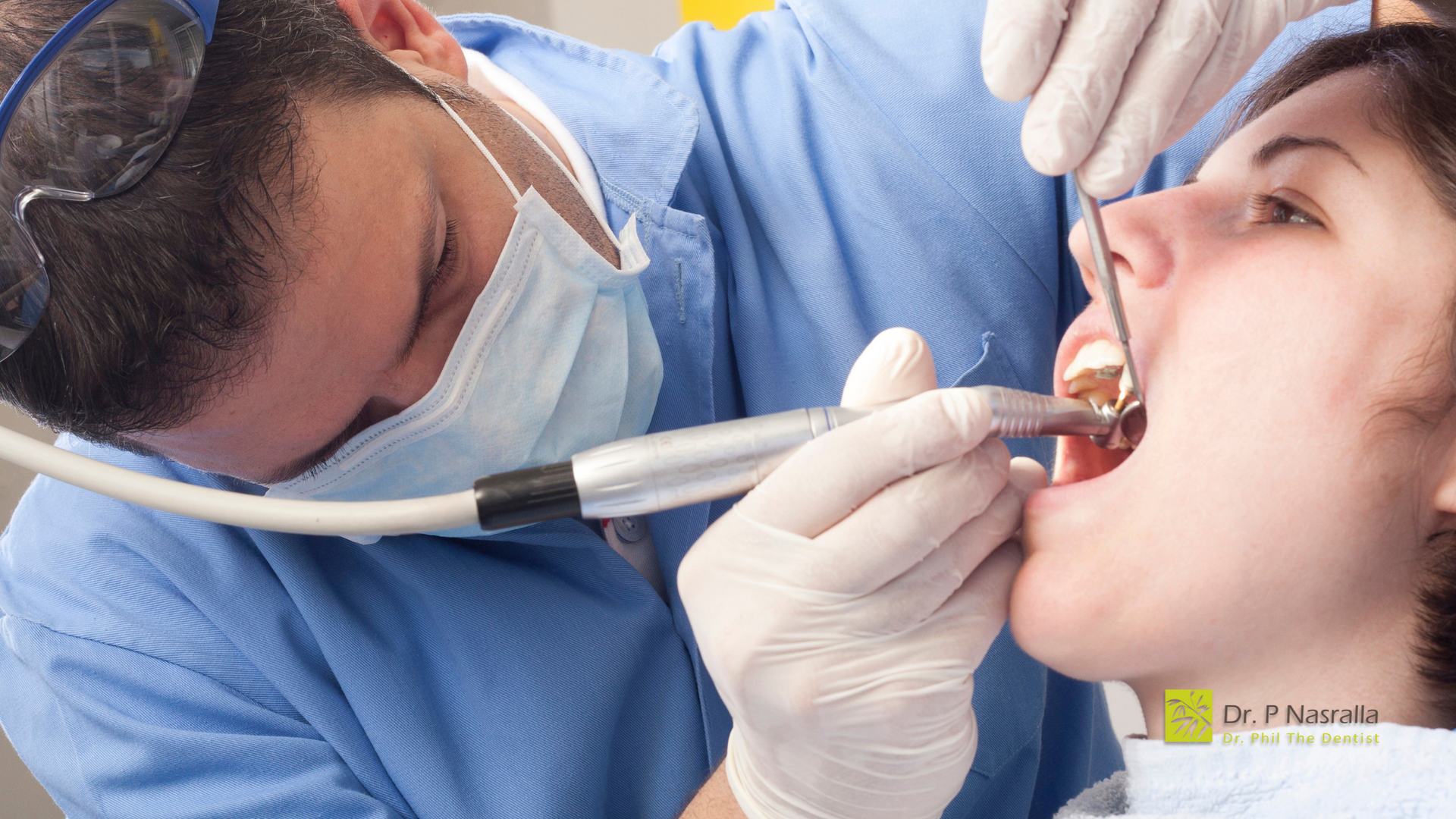 A dentist is examining a woman 's teeth in a dental office.