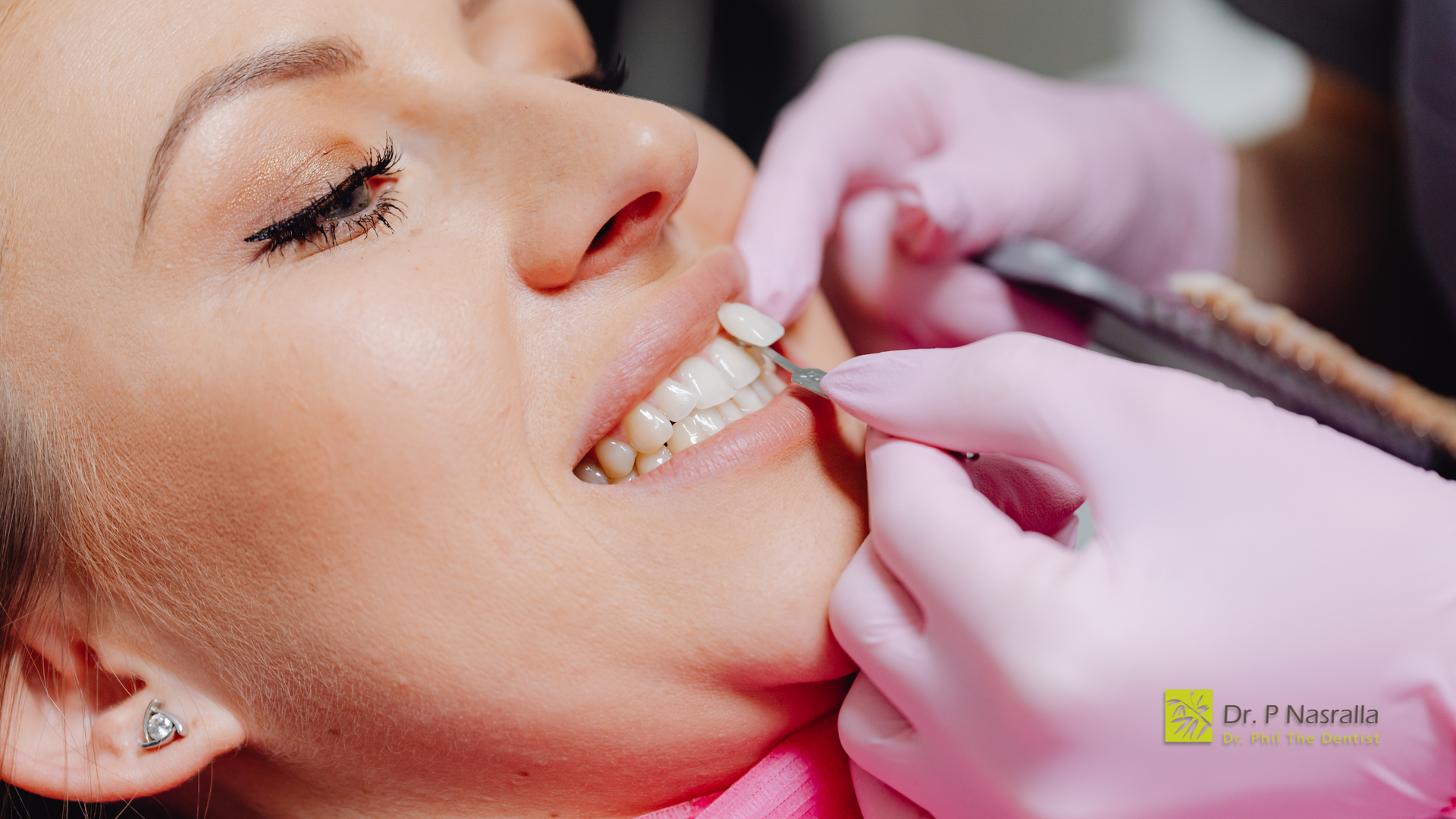 A woman is getting her teeth examined by a dentist.