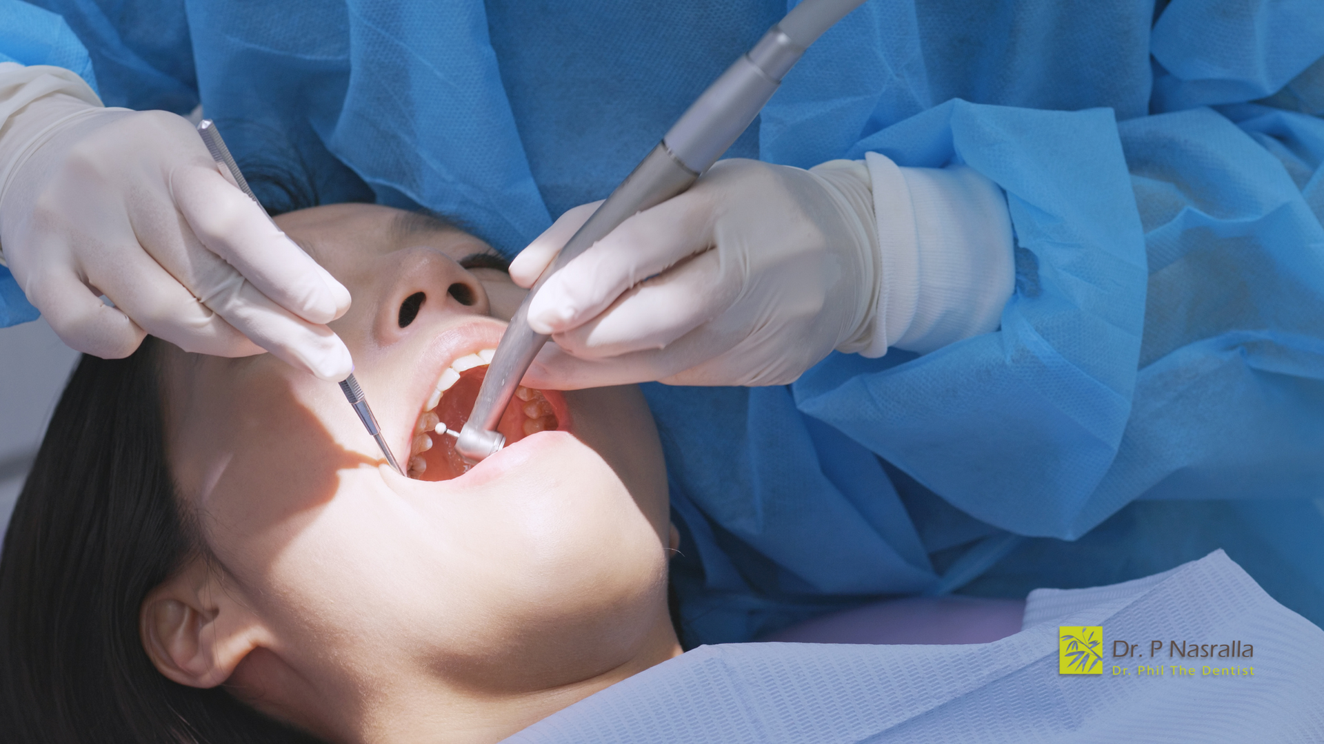 A woman is getting her teeth examined by a dentist.