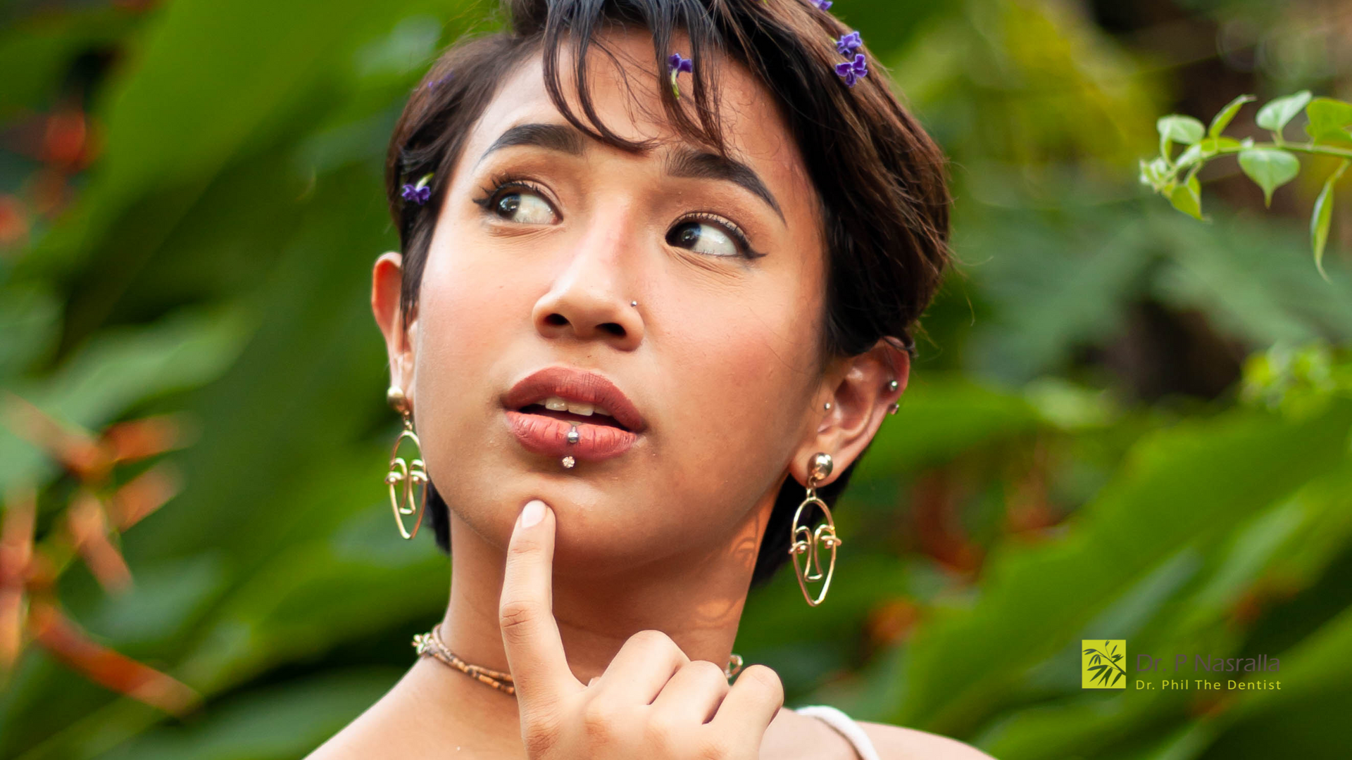 A close up of a woman 's face with a finger on her chin.