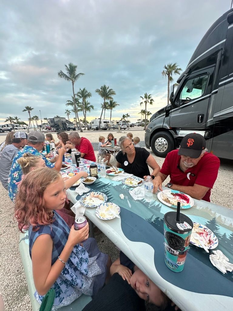 A group of people are sitting at a table eating food.
