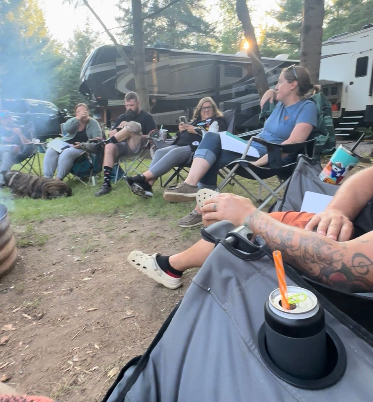 A group of people are sitting around a fire pit