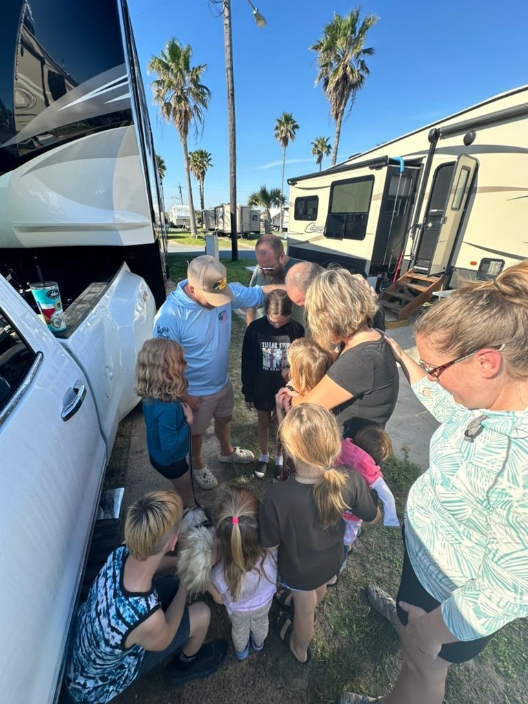 A group of people are standing around a truck.