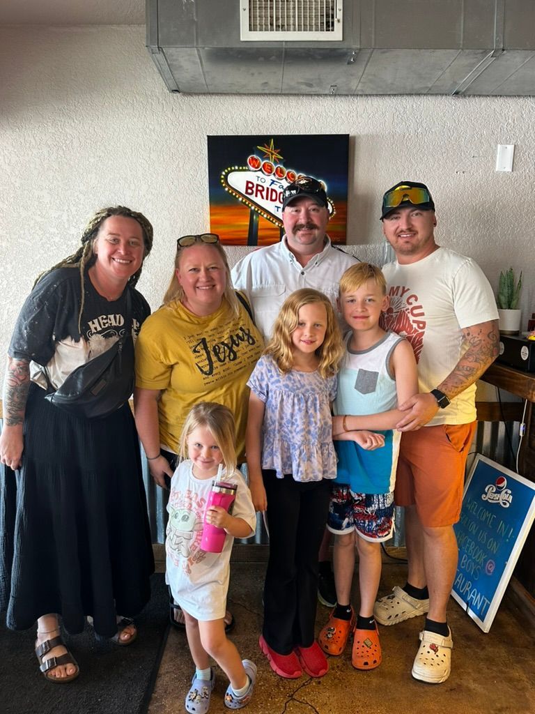 A group of people are posing for a picture in a room.