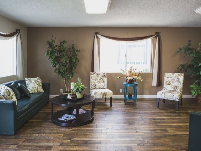 The front office lobby with couches and coffee tables with fresh flowers