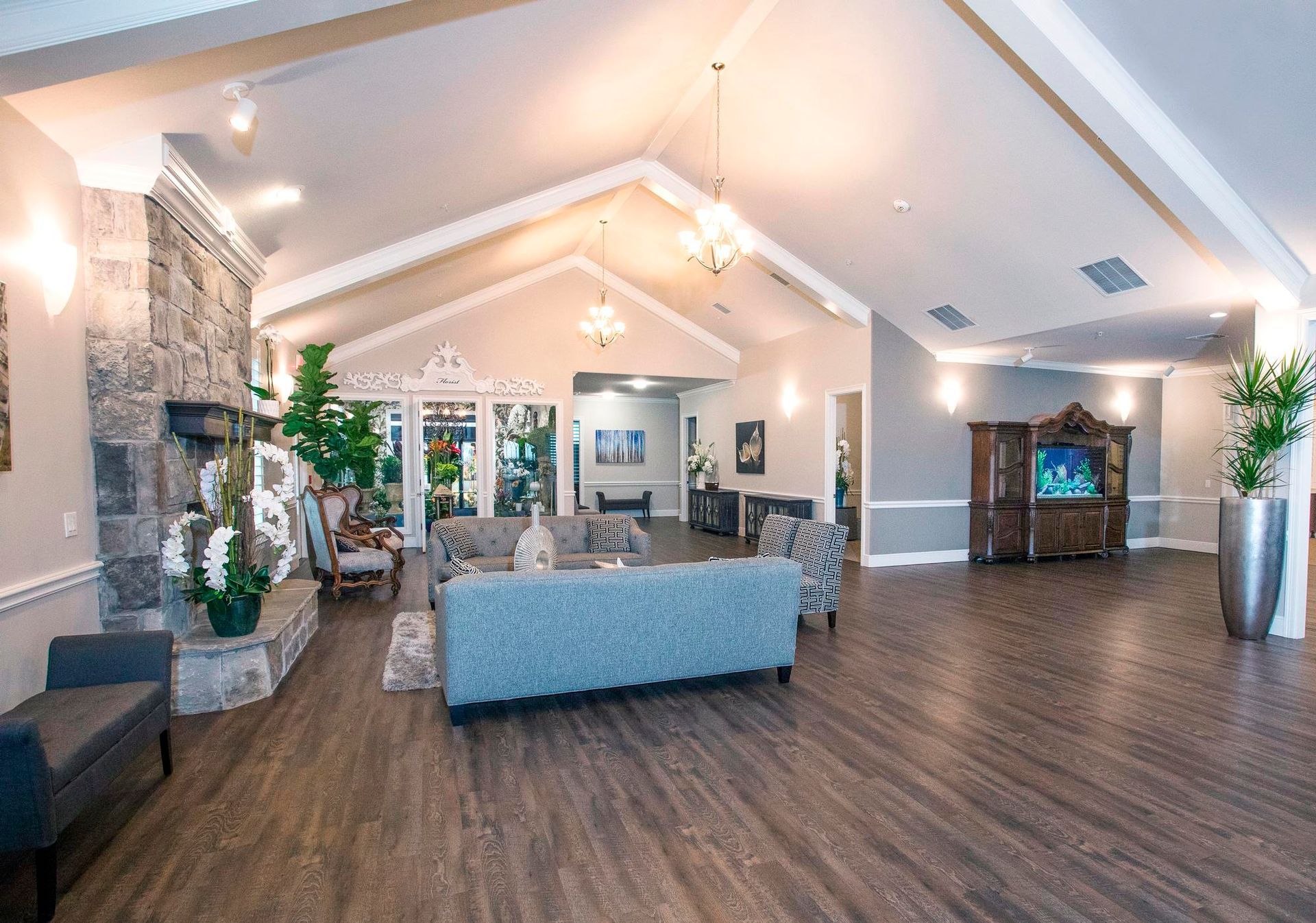A large living room filled with furniture and a fireplace.