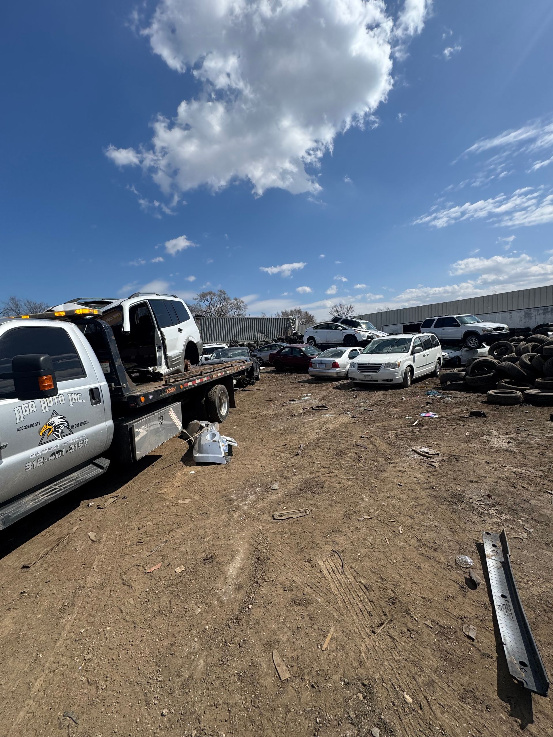A red car is being lifted into the air by a crane.